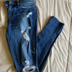 Distressed mid rise blue jeans